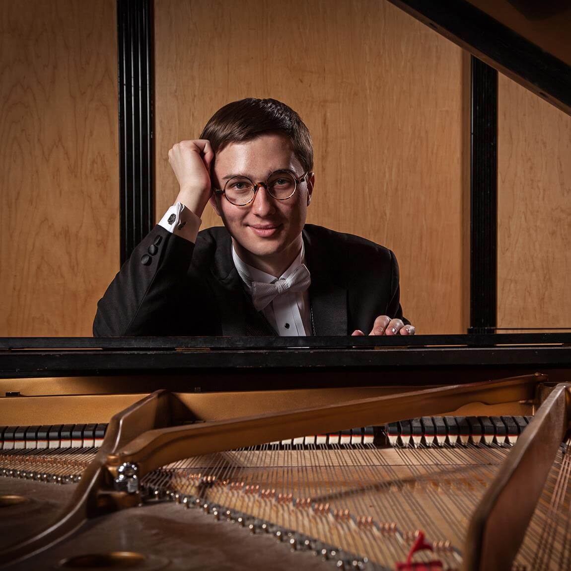 Adam Swanson sits at his piano